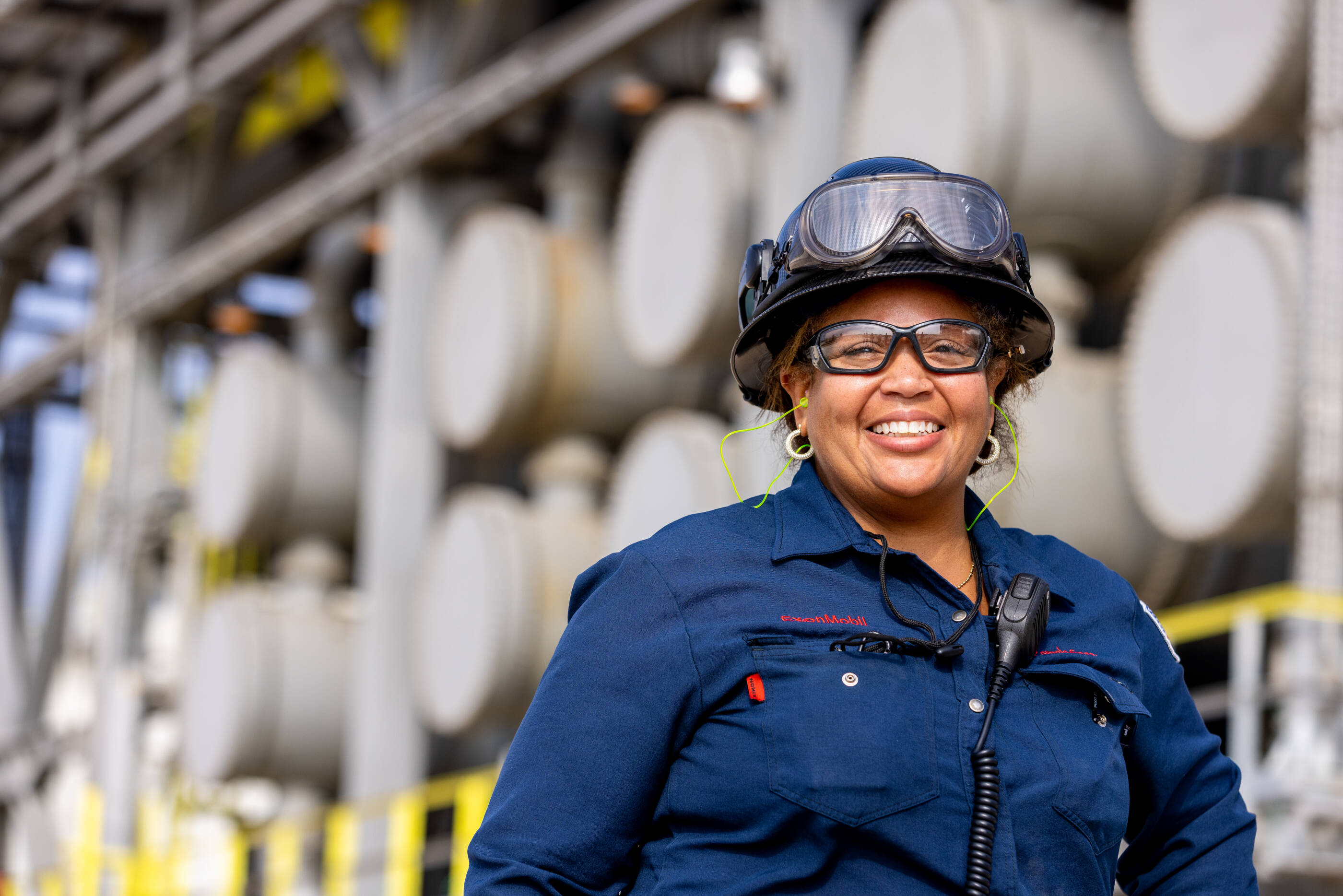 Female employee wearing safety goggles and hard hat