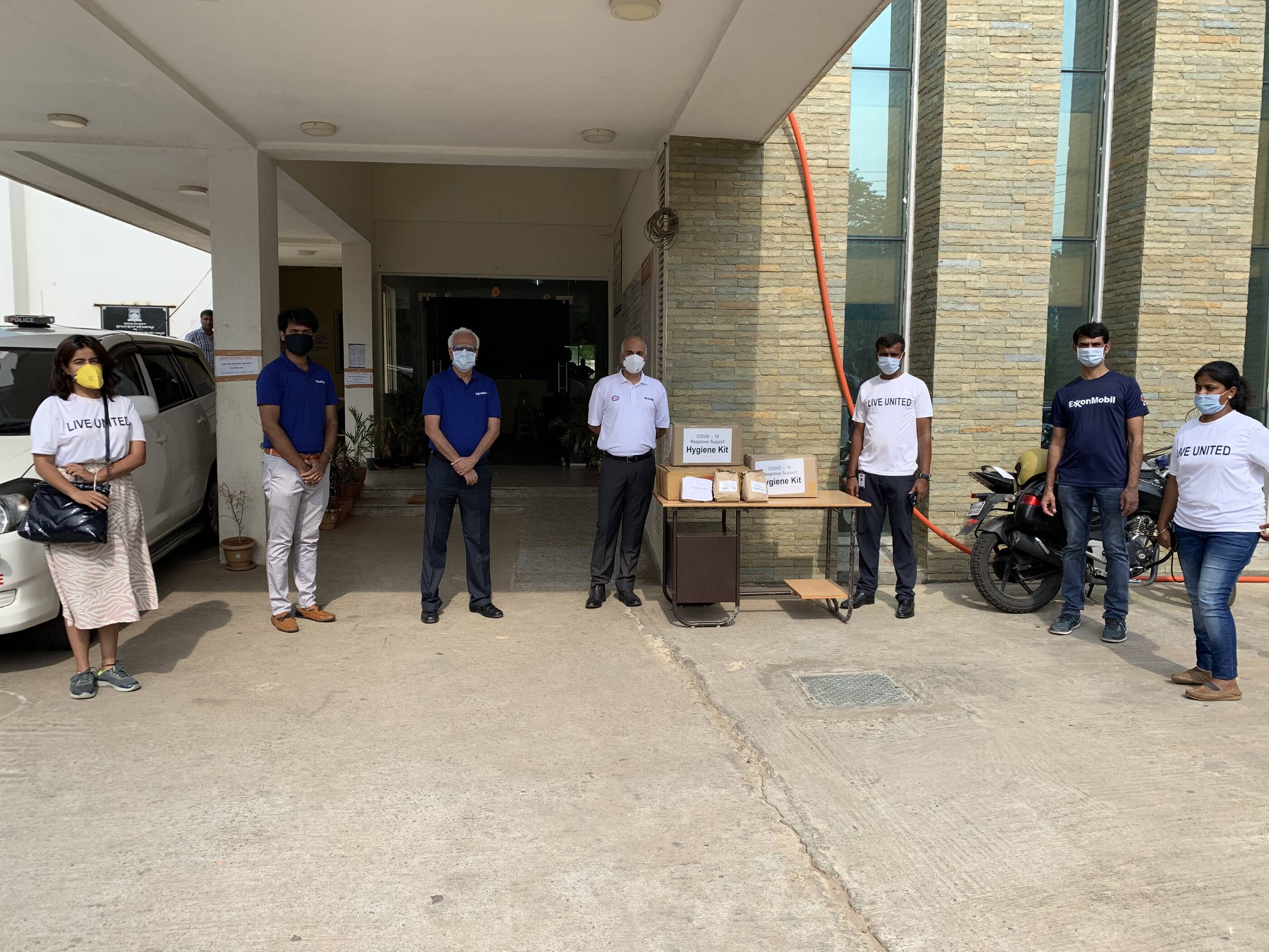 EM representatives and United Way volunteers at Whitefield Police Station, Bengaluru, to hand over hygiene kits